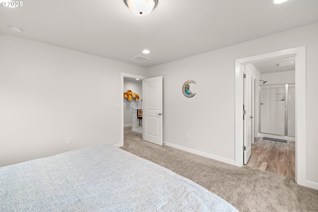 bedroom featuring light colored carpet and connected bathroom