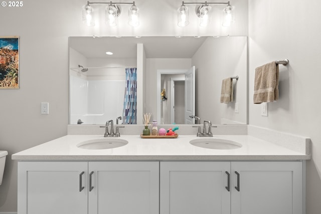 bathroom featuring a shower with shower curtain and vanity