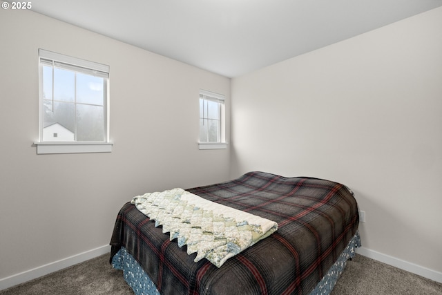 bedroom featuring dark carpet