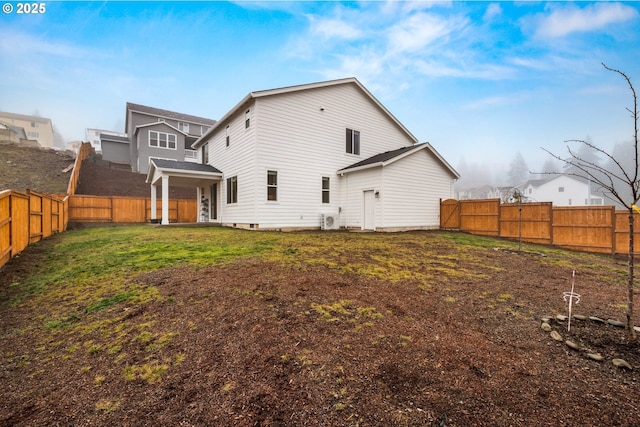 rear view of house with a lawn