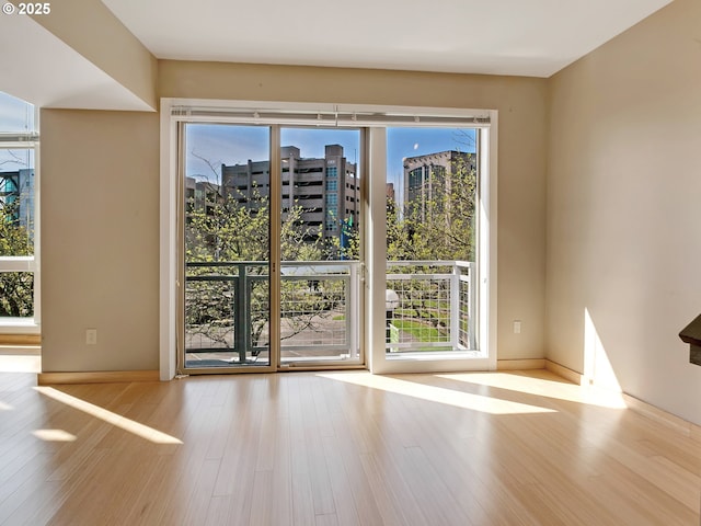 12600 SW Crescent St Unit 219, Beaverton, OR 97005 - doorway to outside with baseboards, wood finished floors, and a healthy amount of sunlight