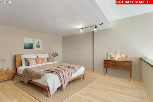 12600 SW Crescent St Unit 219, Beaverton, OR 97005 - bedroom with track lighting and light wood-style flooring