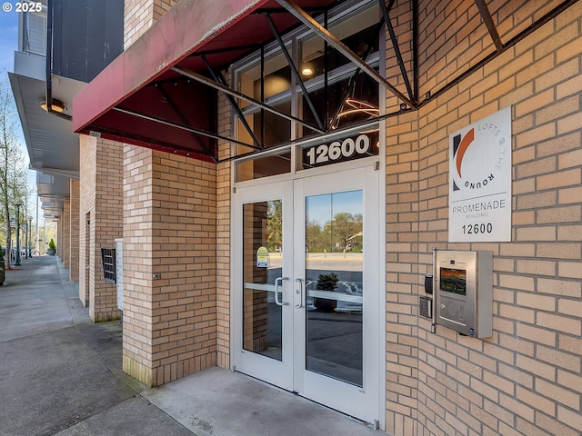 12600 SW Crescent St Unit 219, Beaverton, OR 97005 - view of exterior entry with french doors and brick siding