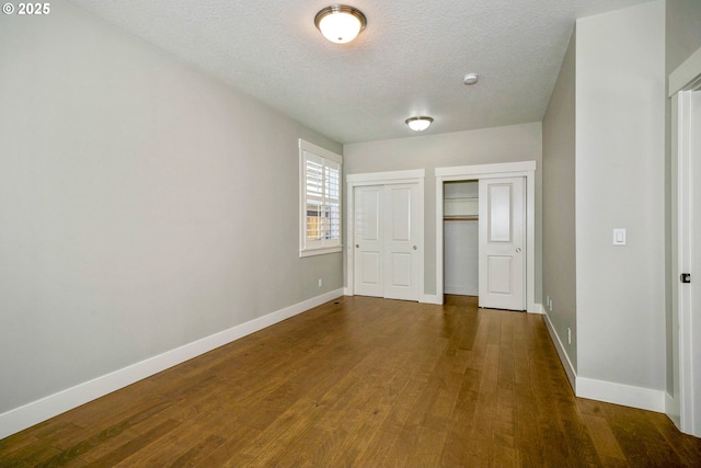 1715 York Butte Ave, Salem, OR 97306 - unfurnished bedroom featuring baseboards, a textured ceiling, and wood finished floors