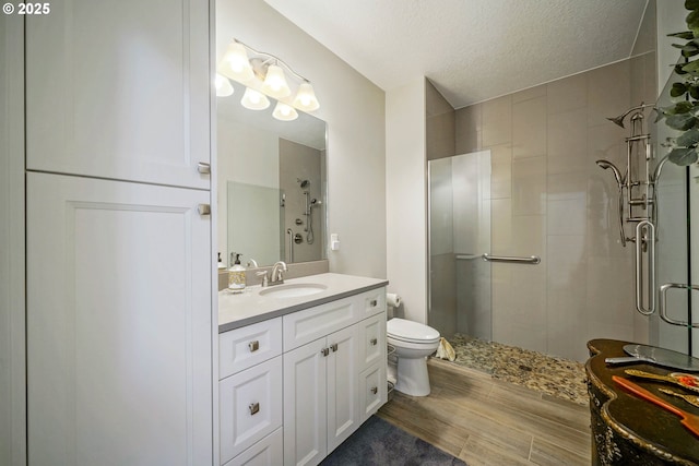 1715 York Butte Ave, Salem, OR 97306 - bathroom featuring a stall shower, vanity, toilet, and a textured ceiling