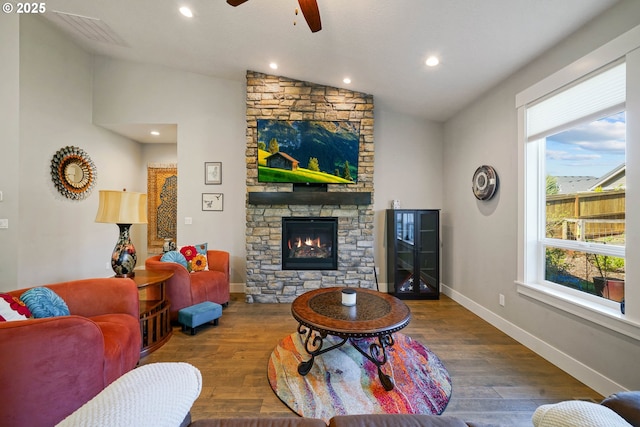 1715 York Butte Ave, Salem, OR 97306 - living room with a ceiling fan, vaulted ceiling, a stone fireplace, visible vents, and wood finished floors