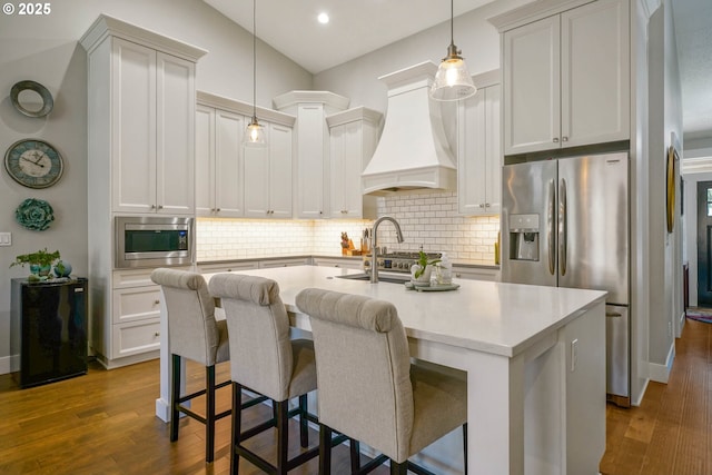 1715 York Butte Ave, Salem, OR 97306 - kitchen featuring stainless steel appliances, tasteful backsplash, an island with sink, dark wood-style floors, and custom range hood