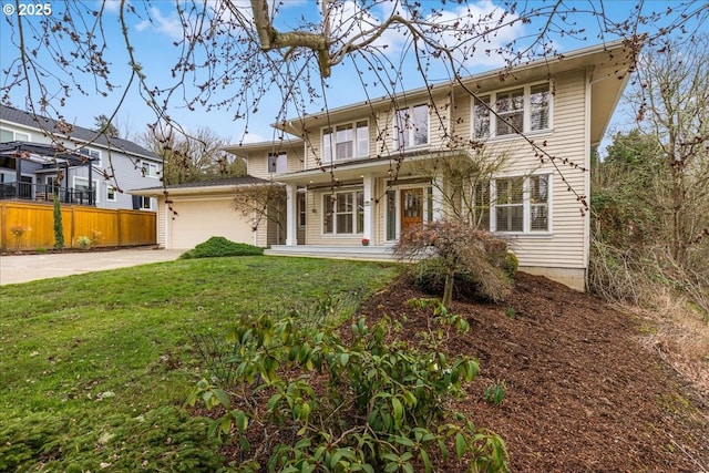 view of front of house with a front lawn, fence, a garage, and driveway