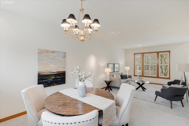 dining area with baseboards, an inviting chandelier, and light carpet