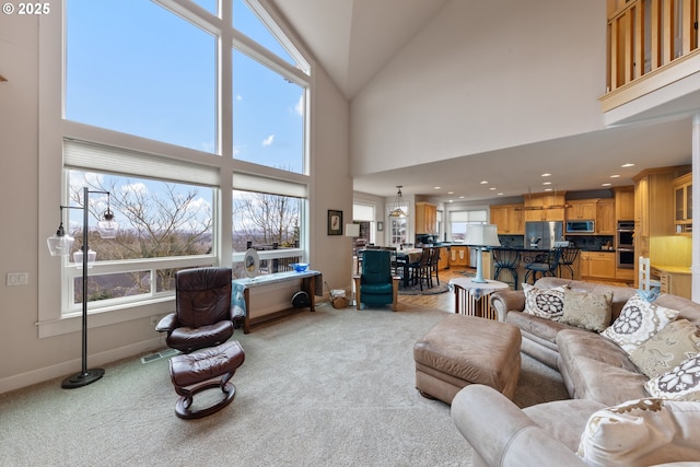 living room featuring light carpet and high vaulted ceiling