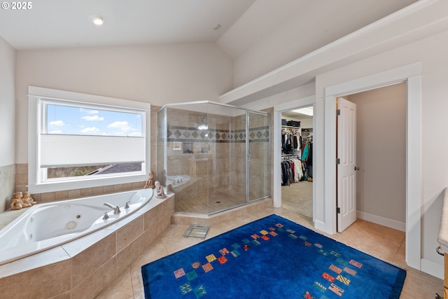 bathroom with tile patterned flooring, separate shower and tub, and lofted ceiling