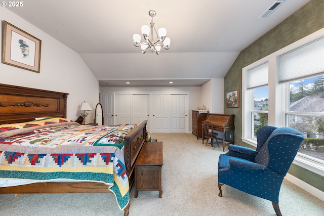 carpeted bedroom with a chandelier, lofted ceiling, and a closet