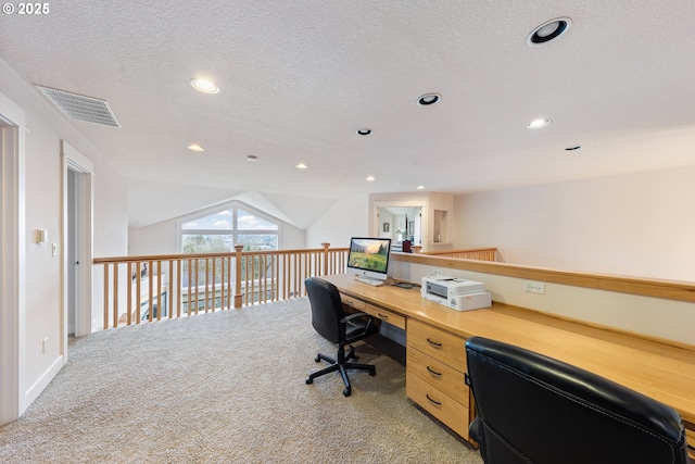 carpeted office space with a textured ceiling and lofted ceiling