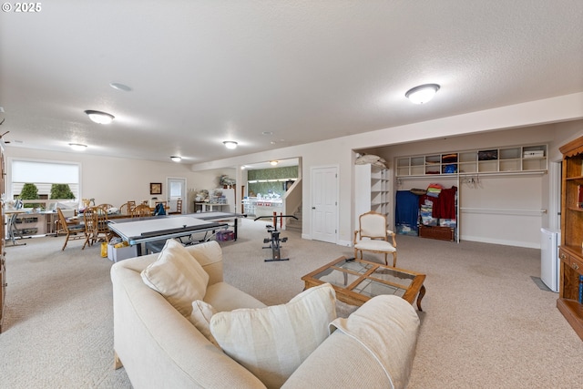 carpeted living room featuring a textured ceiling