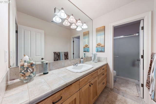 bathroom with vanity, toilet, and an enclosed shower