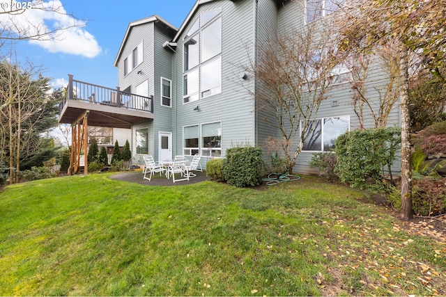 rear view of property with a yard and a patio