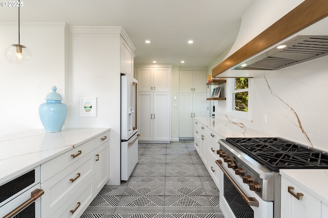 kitchen featuring white cabinetry, light stone counters, custom exhaust hood, hanging light fixtures, and high quality appliances