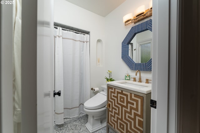 bathroom with tile patterned flooring, vanity, and toilet