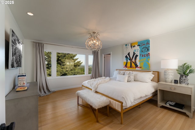 bedroom featuring a notable chandelier and light hardwood / wood-style floors