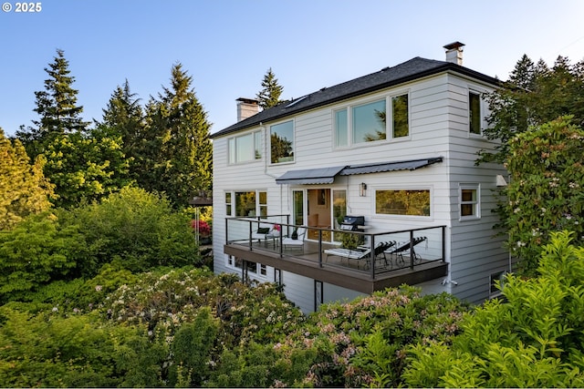 rear view of property featuring a balcony