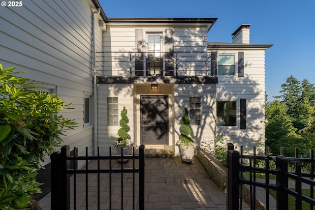 view of front of house featuring a balcony