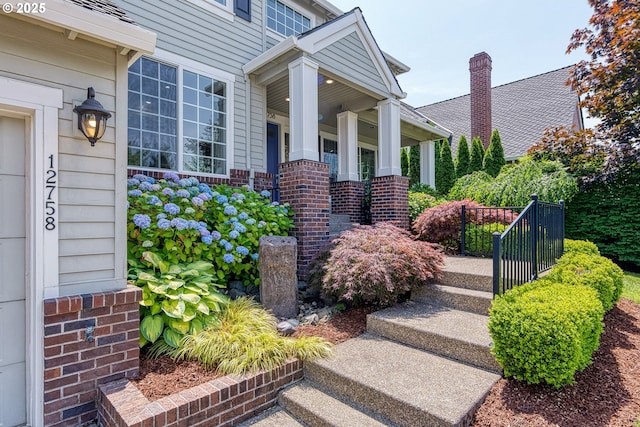 12758 NW Waker Dr, Portland, OR 97229 - property entrance with a porch and brick siding