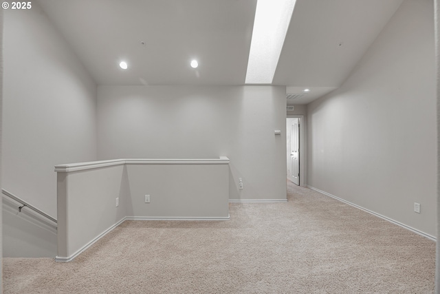 carpeted empty room with baseboards and recessed lighting