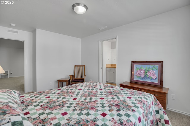 carpeted bedroom featuring visible vents and baseboards