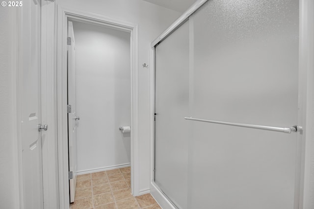 bathroom with a shower with shower door