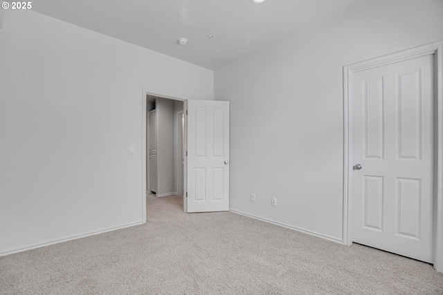 unfurnished bedroom with baseboards and carpet flooring
