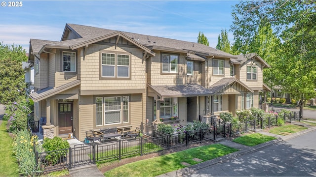 multi unit property with a patio, a gate, fence private yard, and roof with shingles