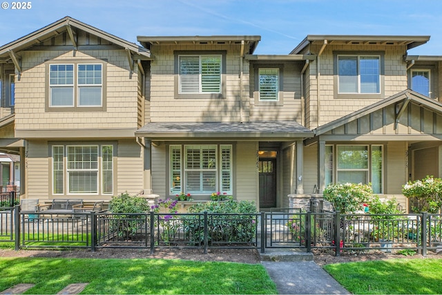 view of front of home featuring covered porch and a fenced front yard