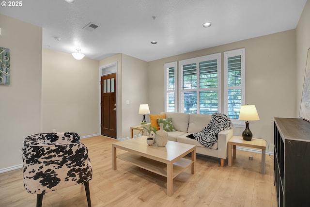 living area featuring baseboards, recessed lighting, light wood-style flooring, and visible vents