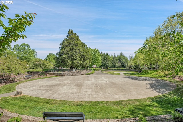view of community featuring a lawn and community basketball court