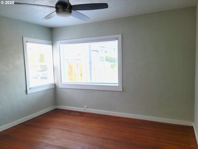 unfurnished room featuring baseboards, ceiling fan, and hardwood / wood-style flooring
