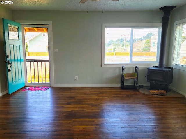 1063 Elrod Ave, Coos Bay, OR 97420 - entryway with baseboards, a wood stove, a ceiling fan, and hardwood / wood-style floors