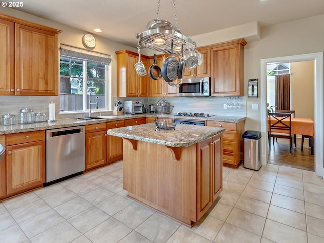 7913 SW Leiser Ln, Portland, OR 97224 - kitchen featuring stainless steel appliances, decorative backsplash, light stone counters, plenty of natural light, and recessed lighting
