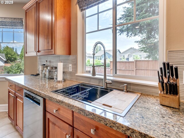 7913 SW Leiser Ln, Portland, OR 97224 - kitchen featuring dishwasher, healthy amount of natural light, brown cabinets, and tasteful backsplash