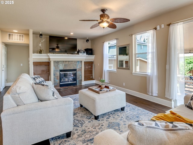 7913 SW Leiser Ln, Portland, OR 97224 - living room featuring a tiled fireplace, a ceiling fan, wood finished floors, healthy amount of natural light, and recessed lighting