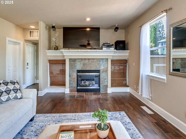 7913 SW Leiser Ln, Portland, OR 97224 - living area featuring a tiled fireplace, wood finished floors, and recessed lighting