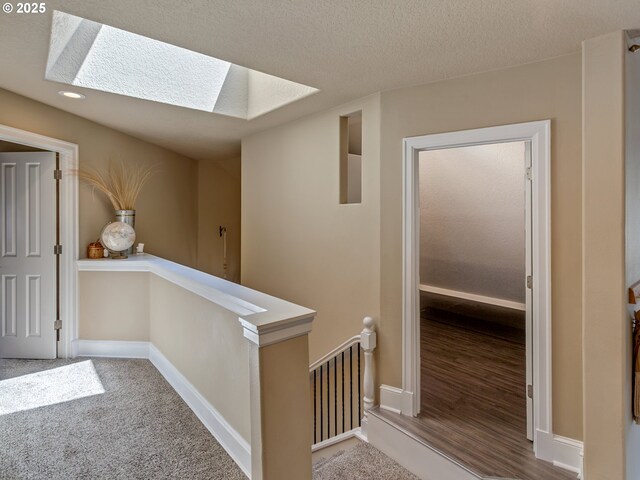 7913 SW Leiser Ln, Portland, OR 97224 - corridor with a skylight, an upstairs landing, and a textured ceiling
