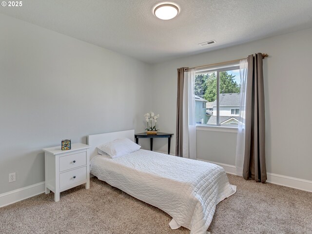 7913 SW Leiser Ln, Portland, OR 97224 - bedroom featuring light carpet and a textured ceiling