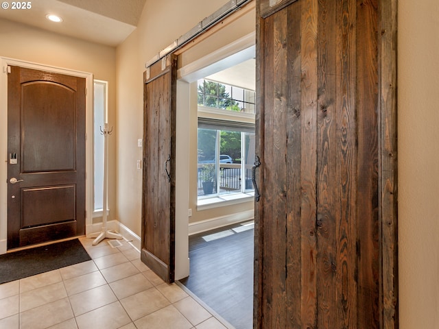7913 SW Leiser Ln, Portland, OR 97224 - foyer featuring light tile patterned floors, a barn door, and recessed lighting