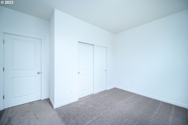 unfurnished bedroom with a closet and carpet floors