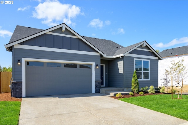 craftsman house featuring a garage and a front yard