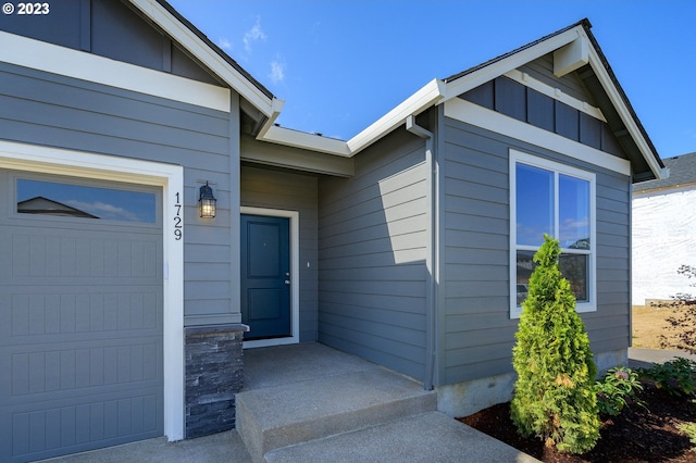 view of exterior entry with a garage