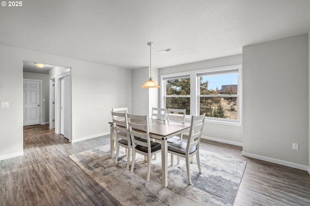 dining area with dark wood-type flooring