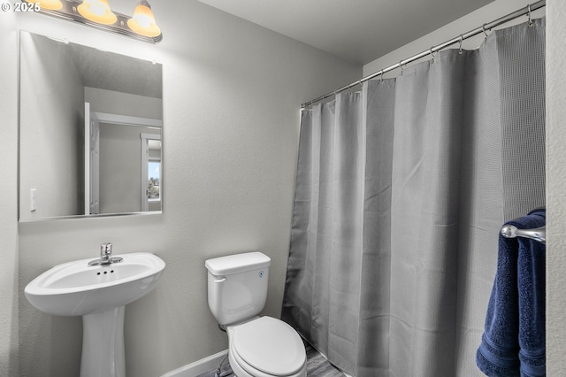 bathroom with a shower with curtain and toilet