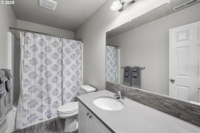 bathroom with decorative backsplash, hardwood / wood-style floors, vanity, and toilet