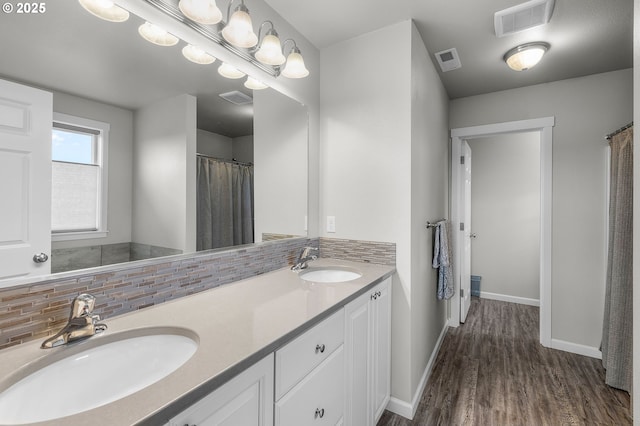 bathroom featuring tasteful backsplash, vanity, and wood-type flooring